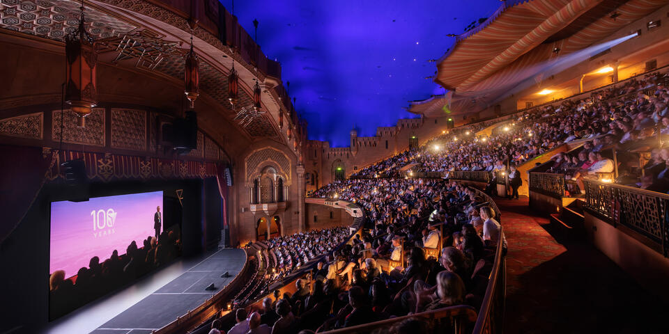 Interior view of the Fox Theatre, with guests seated and watching the film during the premiere event.
