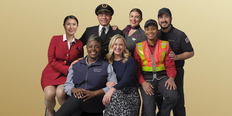 Delta people from across the airline's business pose in this 2024 photo.