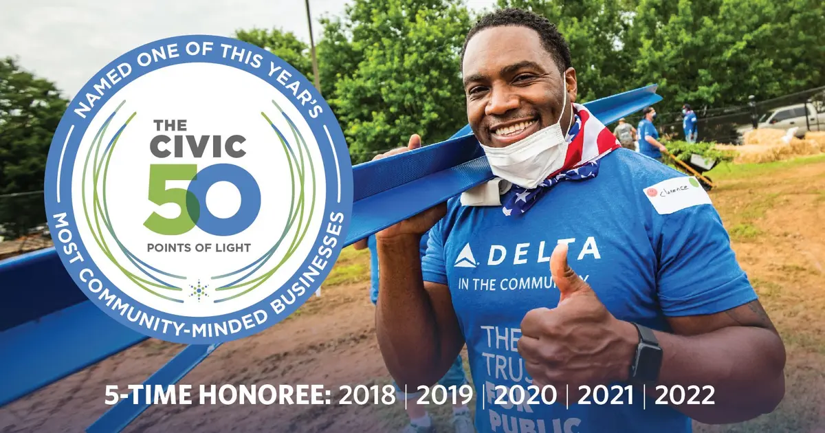 Photo featuring Delta volunteer with badge for winning Points of Light for fifth year in a row.
