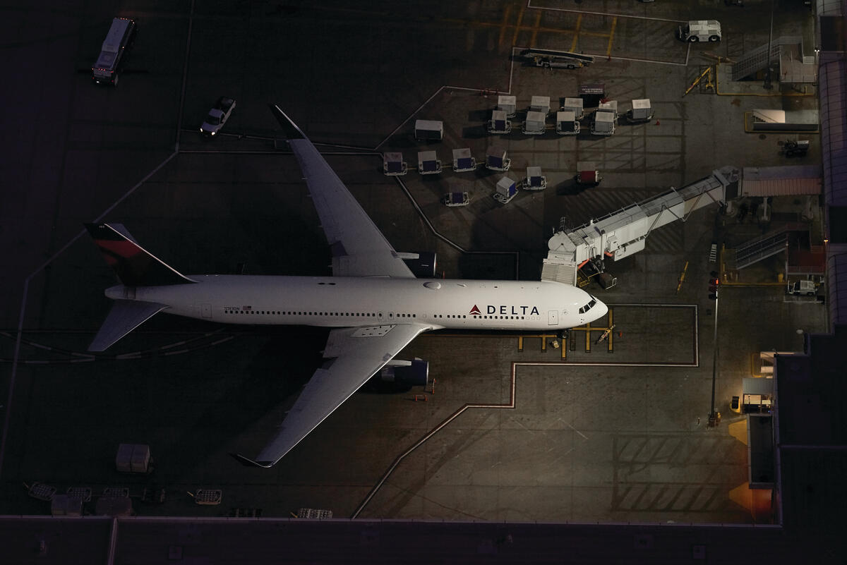 A 767-300 sits near a terminal at LAX airport.