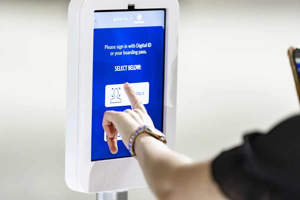 Female customer using Parallel Reality screen to check-in
