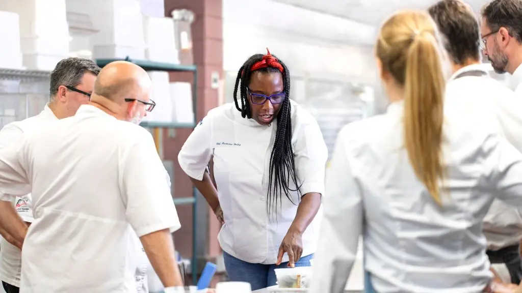Chef Masama Bailey, whose signature Southern flair is now featured on Delta flights departing Atlanta, works with her team in the kitchen.