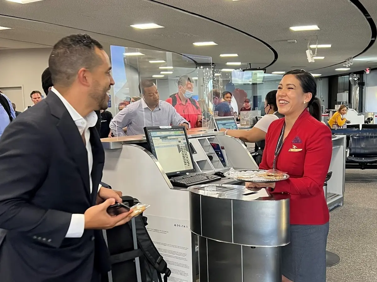 Red Coat Erika Robalino serves a customer. 