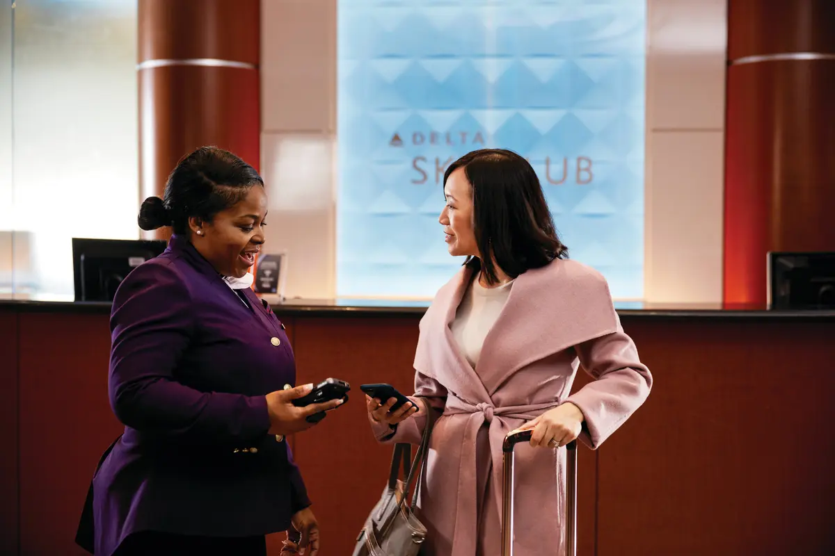 A customer checking in to a Delta Sky Club