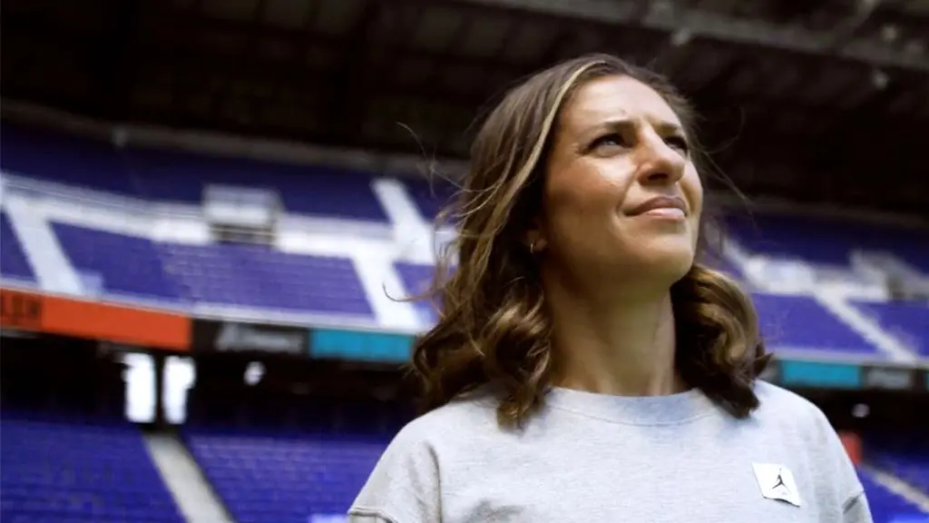 Close up of soccer legend Carli Lloyd standing in a soccer stadium