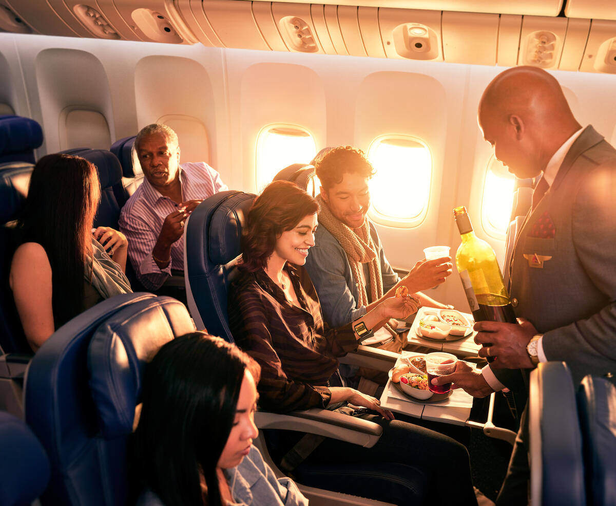 Delta Flight Attendant Robert F. serves customers on board.