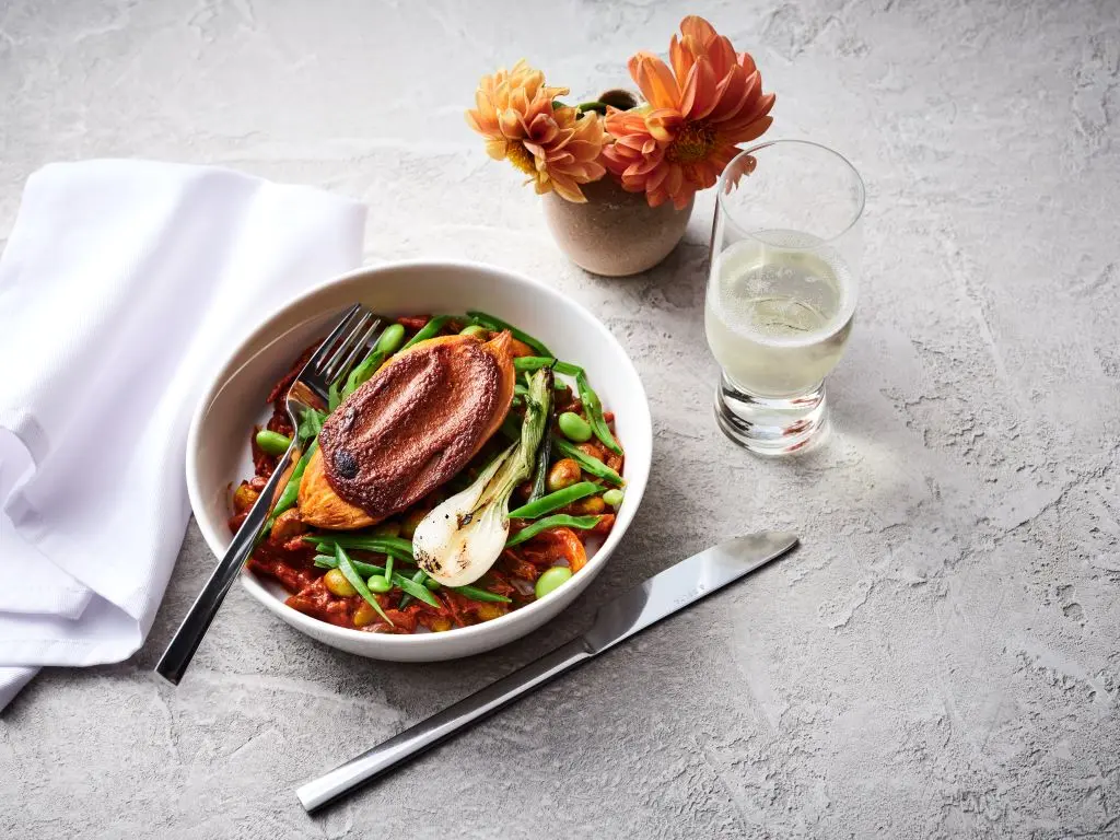 A bowl of roasted sweet potato tagine with chermoula sauce
