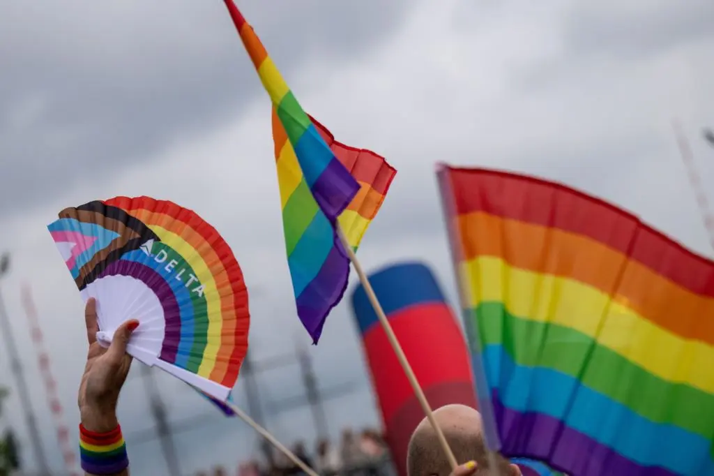 Pride flags with the Delta logo flown at the Amsterdam Canal Parade