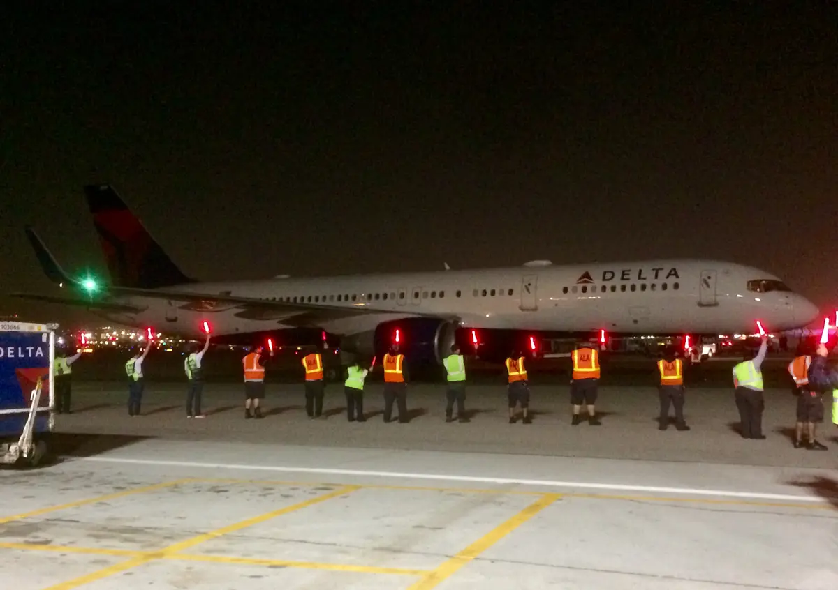 Delta employees usher in the first flight to Delta's new home at LAX during the airline's large terminal move that began in 2017.